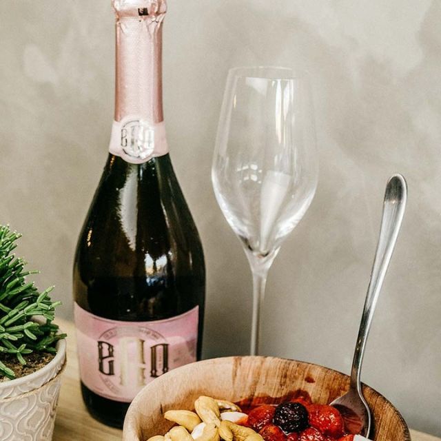 Bottle of sparkling drink with snacks